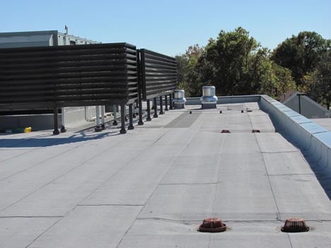 Polymer-modified bitumen system being installed by commercial contractor Benton Roofing