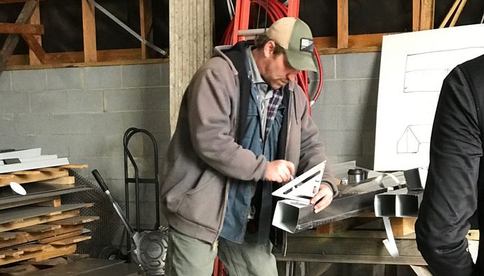 Man measuring custom sheet metal fabrication